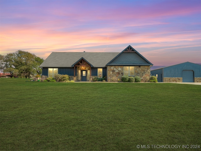 view of front of property with an outbuilding, a garage, and a lawn