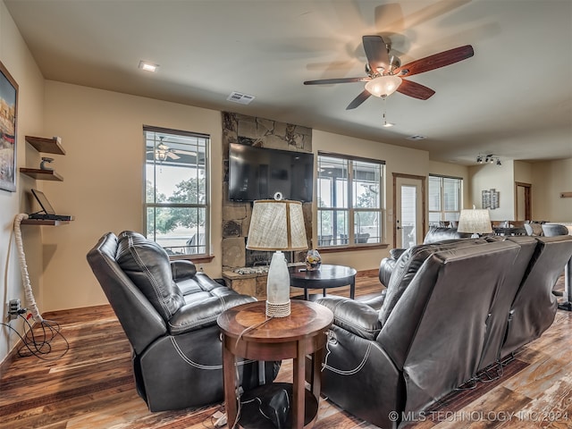 living room featuring ceiling fan, wood-type flooring, and plenty of natural light