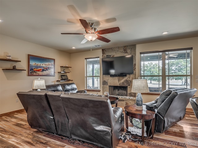 living room with a fireplace, hardwood / wood-style flooring, and ceiling fan