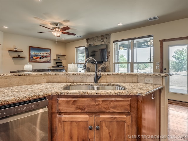 kitchen with sink, light hardwood / wood-style flooring, dishwasher, and plenty of natural light