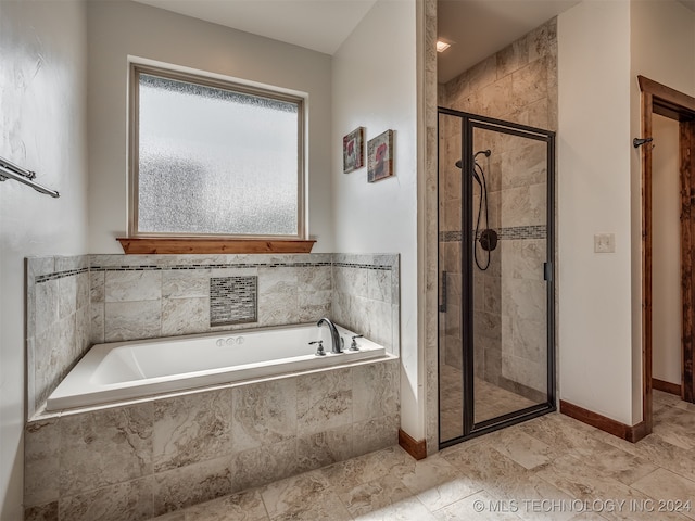 bathroom featuring shower with separate bathtub