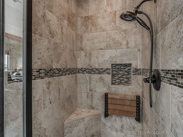 bathroom with tiled shower