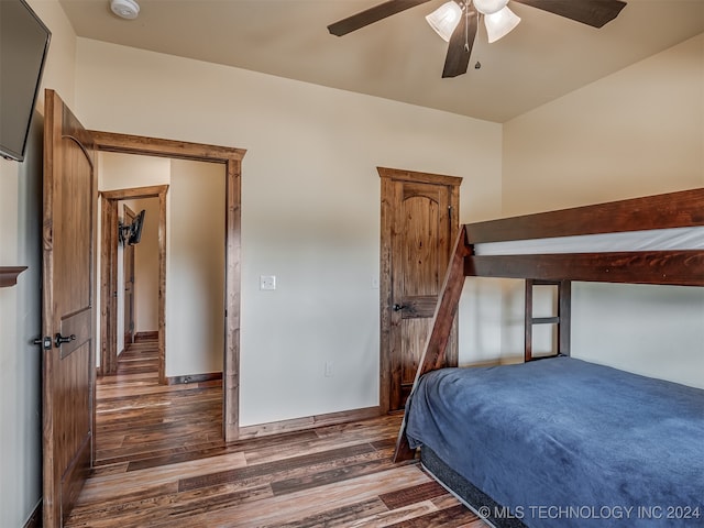 bedroom with dark hardwood / wood-style floors and ceiling fan