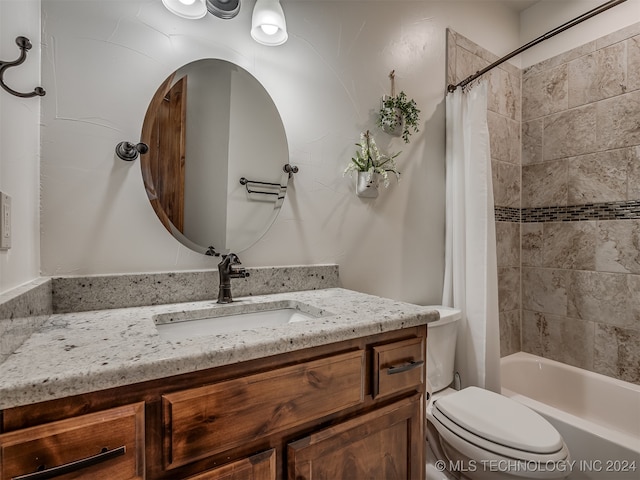 full bathroom featuring toilet, shower / bath combo, and vanity