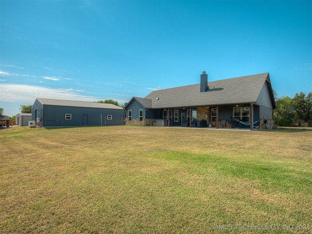 rear view of house with a yard