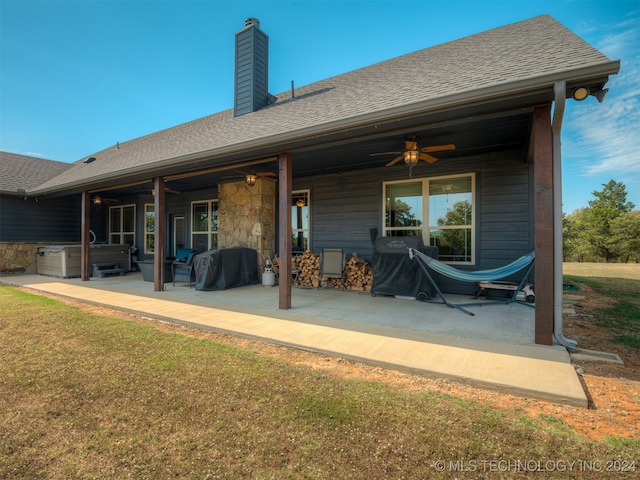 back of property featuring a yard, ceiling fan, and a patio