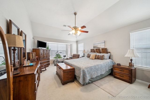 carpeted bedroom with ceiling fan and lofted ceiling