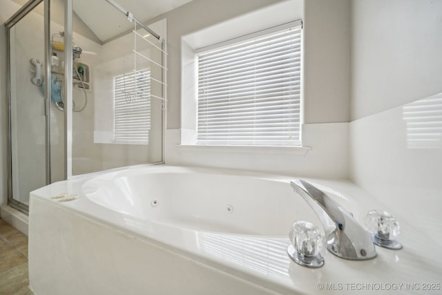 bathroom with separate shower and tub and tile patterned flooring