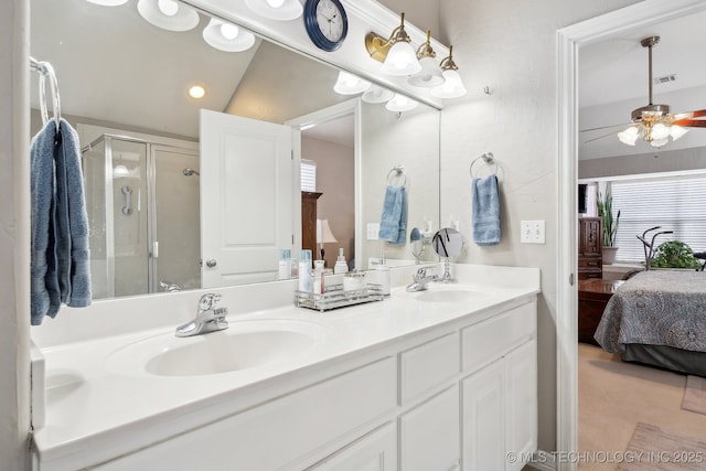 bathroom featuring ceiling fan, vanity, an enclosed shower, and a wealth of natural light