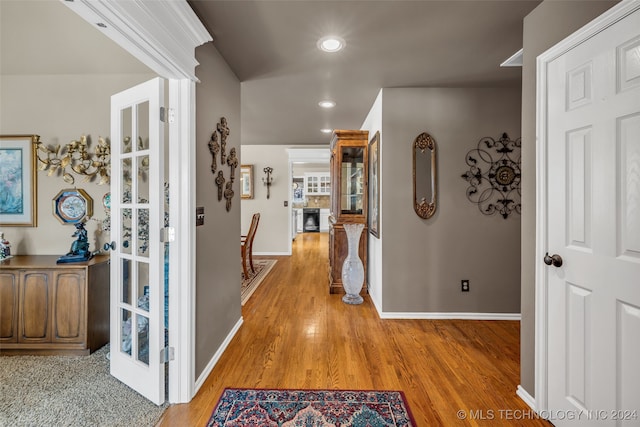 hall featuring hardwood / wood-style floors and french doors