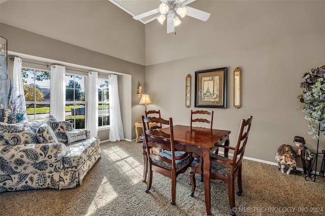 dining space featuring high vaulted ceiling, ceiling fan, light carpet, and a wealth of natural light