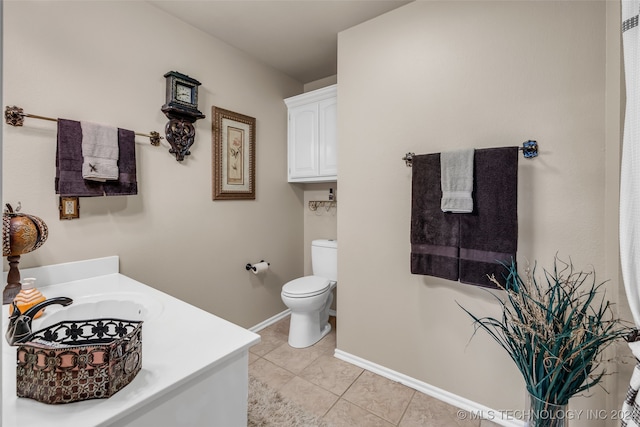 bathroom with tile patterned floors, vanity, and toilet