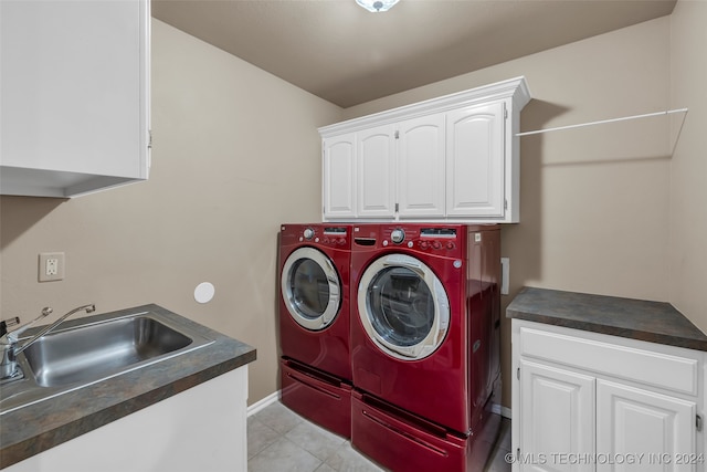 laundry room with separate washer and dryer, sink, and cabinets