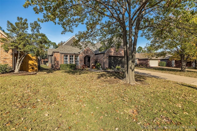 view of front of property featuring a front lawn and a garage