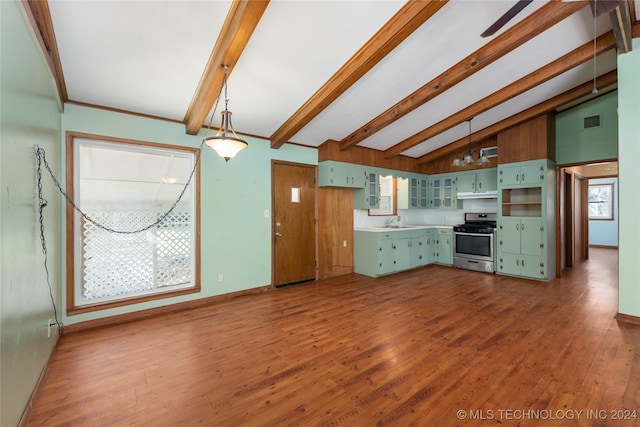 kitchen featuring vaulted ceiling with beams, stainless steel range, wood-type flooring, green cabinets, and sink