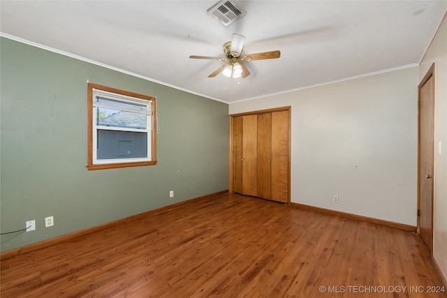 unfurnished bedroom featuring crown molding, wood-type flooring, and ceiling fan