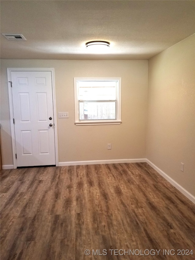 unfurnished room featuring wood-type flooring