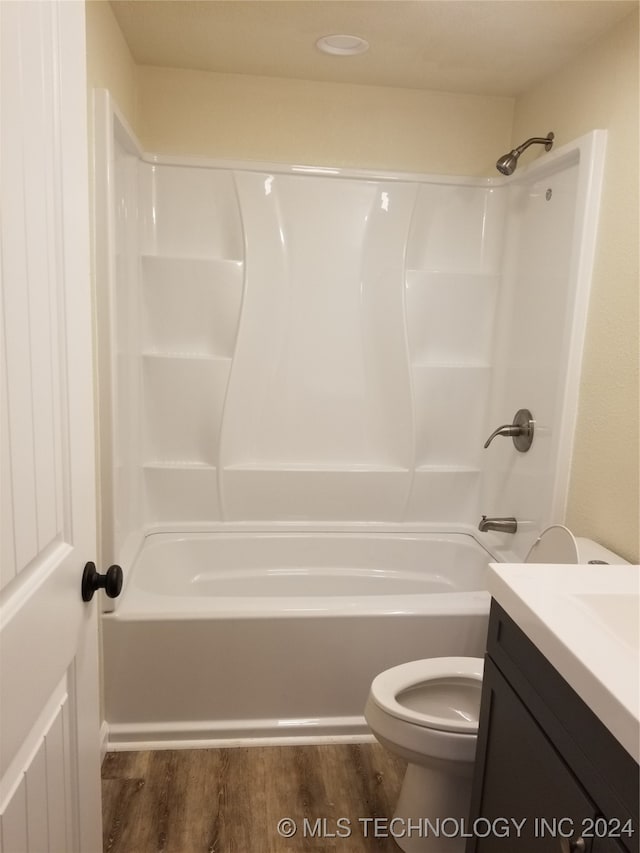 full bathroom with toilet, shower / tub combination, vanity, and wood-type flooring