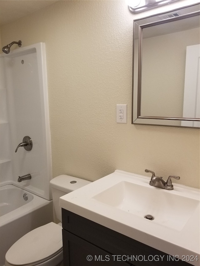 full bathroom with vanity, toilet, and washtub / shower combination