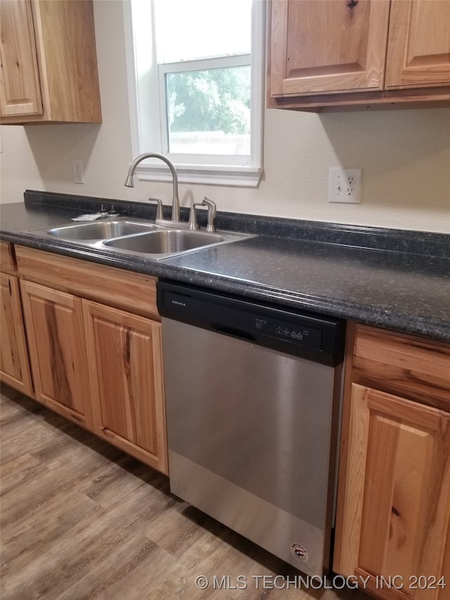 kitchen featuring light hardwood / wood-style floors, dishwasher, and sink