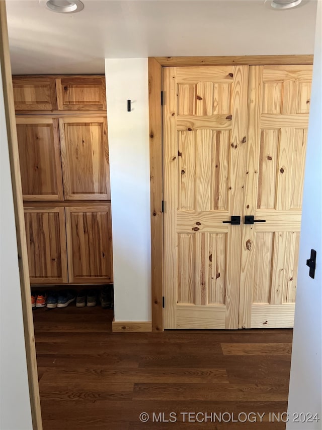 interior space featuring wood finished floors and baseboards