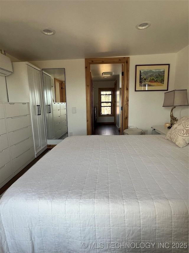 bedroom with recessed lighting and an AC wall unit