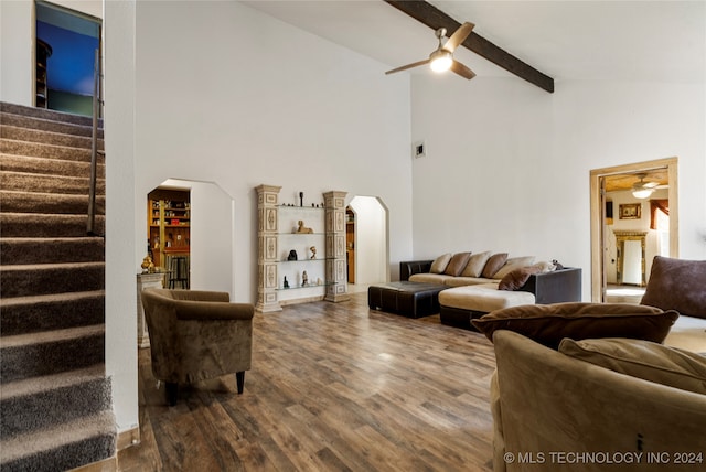 living room featuring hardwood / wood-style floors, beam ceiling, high vaulted ceiling, and ceiling fan