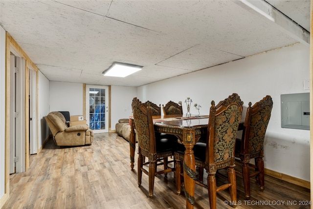 dining room with hardwood / wood-style floors and electric panel