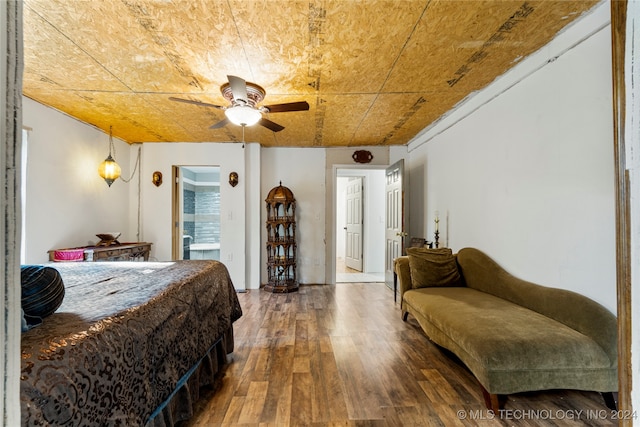 bedroom featuring ceiling fan, hardwood / wood-style flooring, and ensuite bath