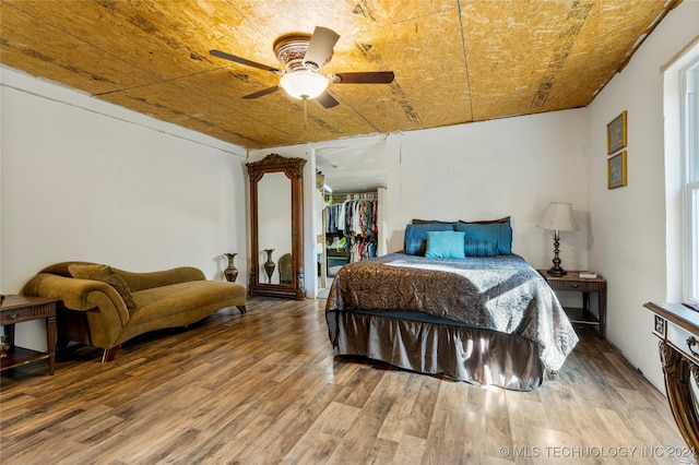 bedroom with a closet, wood-type flooring, and ceiling fan