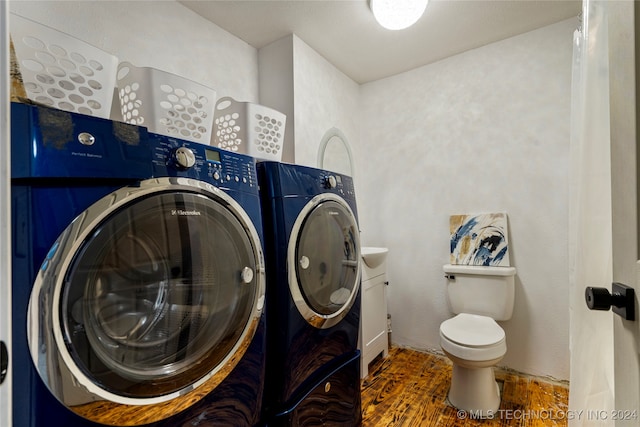 laundry room featuring wood-type flooring and washer and clothes dryer