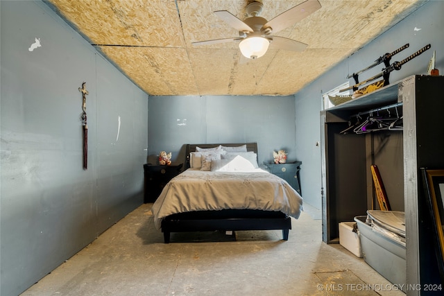 bedroom with concrete flooring and ceiling fan