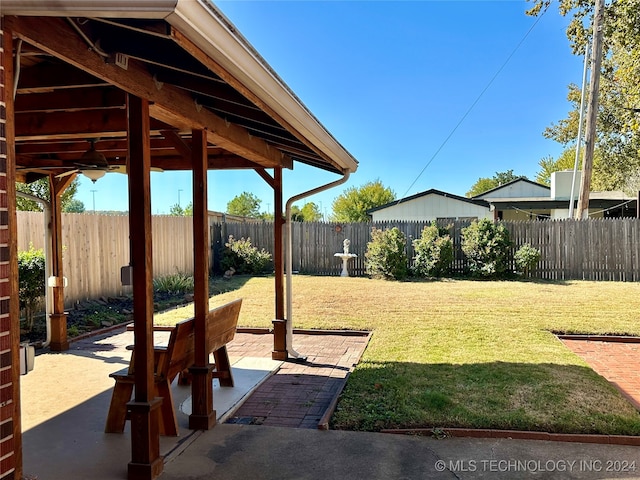 view of yard featuring a patio and ceiling fan