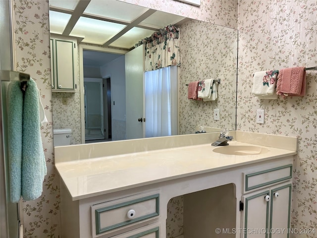 bathroom featuring vanity and toilet