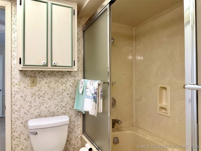 bathroom featuring toilet and enclosed tub / shower combo