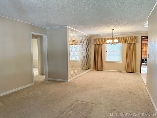 carpeted empty room with a chandelier, crown molding, and a textured ceiling