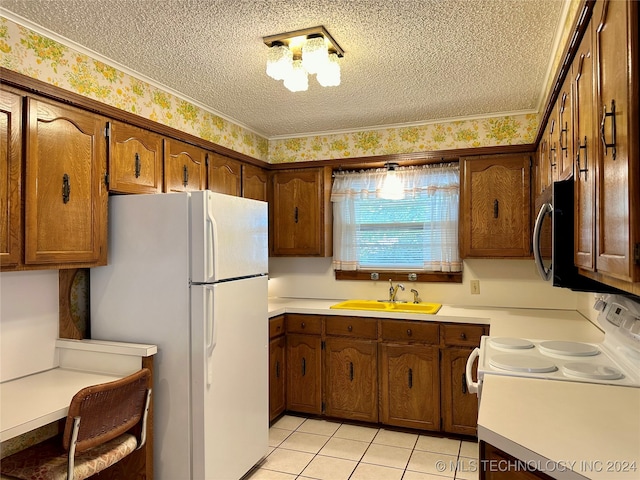 kitchen featuring white appliances, a textured ceiling, and sink