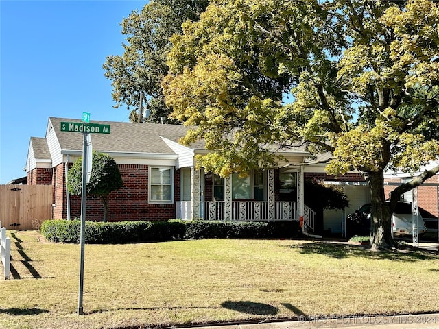 view of front of property with a porch and a front lawn