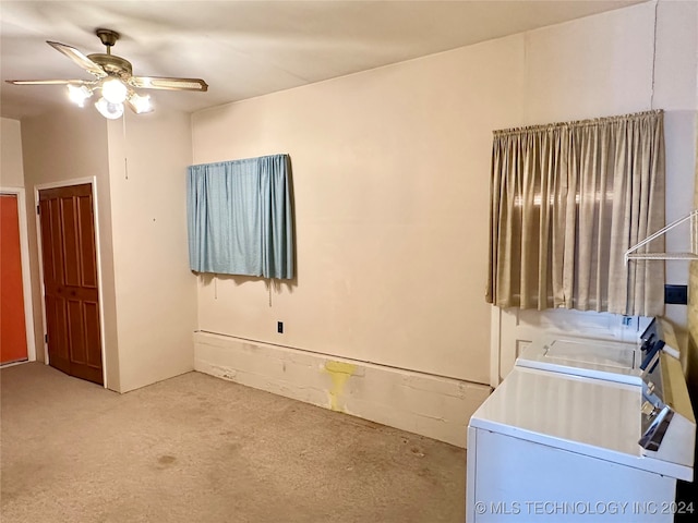 interior space featuring washing machine and clothes dryer and ceiling fan