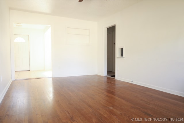 empty room with ceiling fan and wood-type flooring