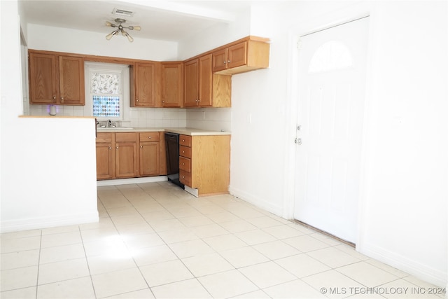 kitchen with light tile patterned floors, decorative backsplash, sink, and dishwasher