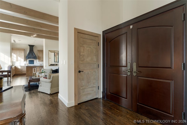 entrance foyer with beamed ceiling and dark hardwood / wood-style flooring