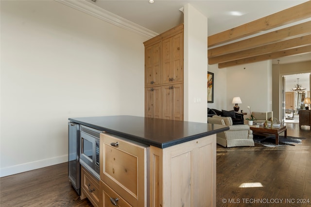 kitchen featuring beam ceiling, ornamental molding, dark wood-type flooring, and light brown cabinets