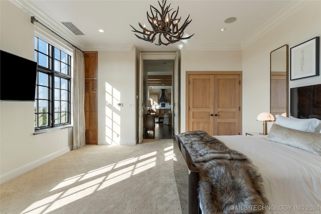 bedroom featuring light carpet, crown molding, and a notable chandelier