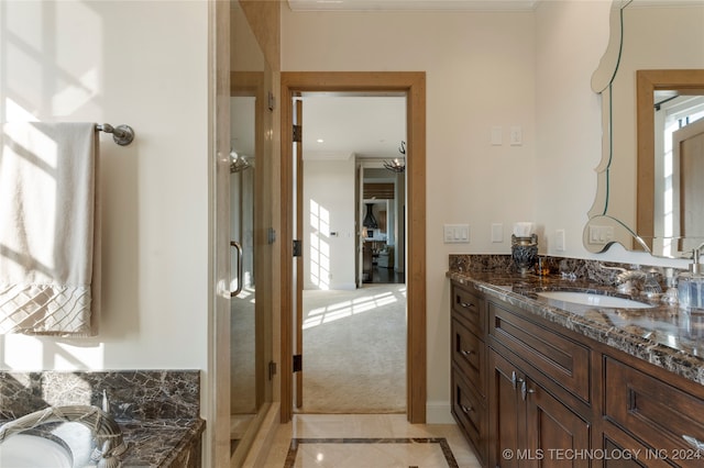 bathroom with vanity, crown molding, walk in shower, and tile patterned flooring