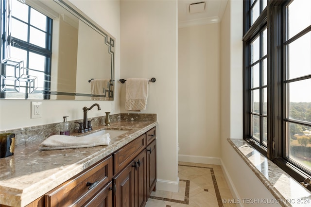 bathroom featuring vanity, ornamental molding, and tile patterned flooring