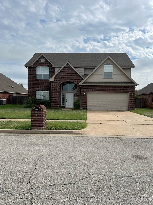 view of front of home with a front yard and a garage