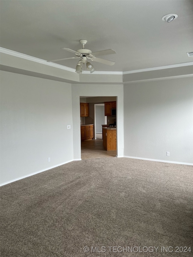 carpeted empty room with ornamental molding and ceiling fan