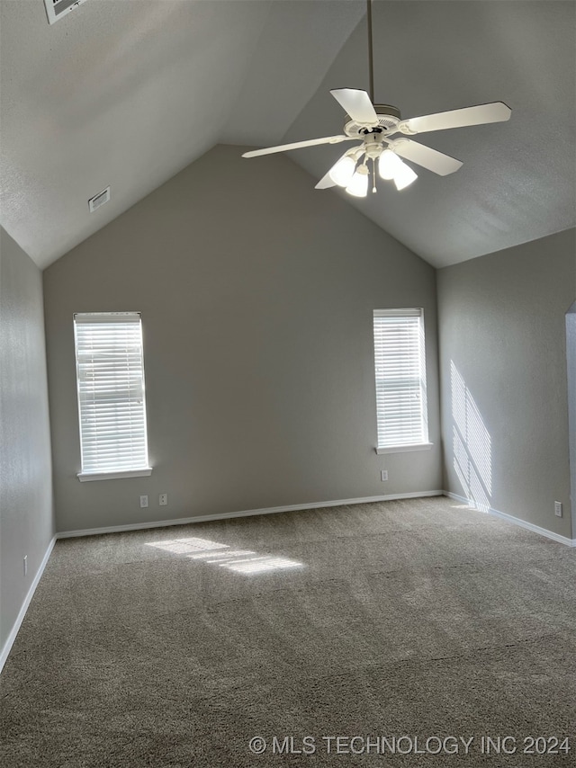 unfurnished room featuring vaulted ceiling, carpet flooring, and ceiling fan