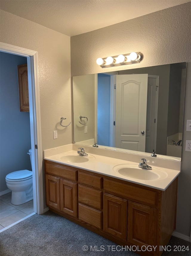 bathroom featuring vanity, toilet, and tile patterned floors